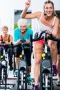 Senior people in gym spinning on fitness bike Royalty Free Stock Photo