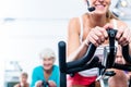 Senior people in gym spinning on fitness bike Royalty Free Stock Photo