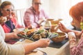 Senior people having vegetarian lunch at home - Mature friends eating bbq vegetables,fresh salads and drinking red wine - Healthy Royalty Free Stock Photo