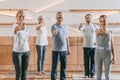 senior people and instructor in sportswear showing thumbs up and smiling at camera