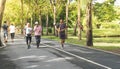 Senior people running in green park in city