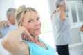 Senior people stretching in fitness room