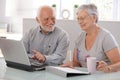 Senior people using laptop smiling
