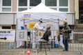 Senior people waiting in covid-19 testing center outdoors on street, coronavirus concept.