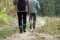 Senior people walking with sticks on trekking in the mountain