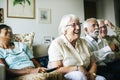 Senior people watching television together Royalty Free Stock Photo
