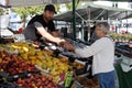 Senior person percahases fruit from fruit vendor Royalty Free Stock Photo