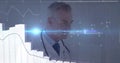 Senior physician in white coat with stethoscope studying data in clinic with bar chart, blue flare Royalty Free Stock Photo