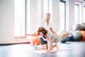 Senior physiotherapist working with a female patient.