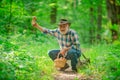 Senior picking wild berries and mushrooms in national park forest. Grandpa.