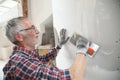 Senior plasterer working on indoor wall Royalty Free Stock Photo