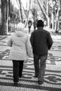 Senior portuguese couple walking on the Av. da Liberdade pedestrian avenue in