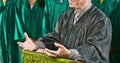 Senior preacher standing at pulpit with choir in background at church Royalty Free Stock Photo