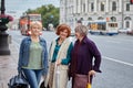 Senior pretty women walk on city street.