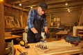 Senior Professional carpenter in uniform working of manual milling machine in the carpentry workshop Royalty Free Stock Photo