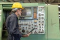 Senior Professional technician engineer male operate control heavy industry machine CNC in factory