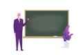 Senior Professor or teacher standing near blank school blackboard. Royalty Free Stock Photo