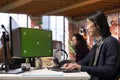 Senior programmer using green screen PC in AI tech startup