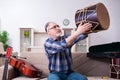 Senior male repairman repairing musical instruments at home Royalty Free Stock Photo