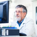 Senior researcher using a computer in the lab