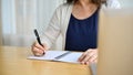 Senior retired aged asian woman writing something on her personal spiral notebook Royalty Free Stock Photo