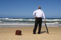 Senior retired business man dreaming of retirement freedom on a beach. Royalty Free Stock Photo