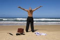 Senior retired business man sunbathing with arms outstretched on tropical caribbean beach, retirement freedom concept Royalty Free Stock Photo