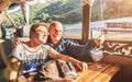 Senior retired couple of happy vacationers taking selfie at Mekong exploration tour with slowboat in Laos PDR - Active elderly