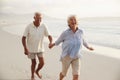 Senior Retired Couple Running Along Beach Hand In Hand Together Royalty Free Stock Photo