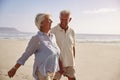 Senior Retired Couple Walking Along Beach Hand In Hand Together Royalty Free Stock Photo