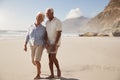 Senior Retired Couple Walking Along Beach Hand In Hand Together Royalty Free Stock Photo
