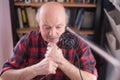 Smiling old elder grandfather talking to webcam on video chat sit at home