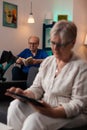 Senior retired woman looking at digital tablet gadget