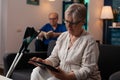 Senior retired woman looking at digital tablet gadget