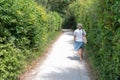 Senior retired woman in pathway forest in ÃÅ½le d`Aix island in France