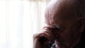 Senior retiree has severe migraine attack. Exhausted elderly man suffering from headache
