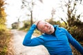 Senior runner doing stretching in sunny autumn nature. Royalty Free Stock Photo