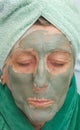 A senior's face is covered by clay facial mask.Close up Royalty Free Stock Photo