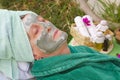 A senior's face is covered by clay facial mask.Close up Royalty Free Stock Photo