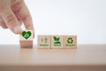 Hand holding heart with earth icon on wood cube health world ,CSR, eco green sustainable living, zero waste, earth day, Royalty Free Stock Photo