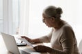 Senior 70s landlady, tenant lady using calculator, online banking app Royalty Free Stock Photo