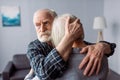 Senior, sad man hugging wife, sick Royalty Free Stock Photo