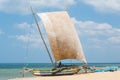 Senior sailor sitting on the sailing boat on the beach