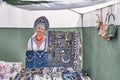 Senior saleswoman in Russian national clothes and kokoshnik in trade tent at Irbit fair, Russia