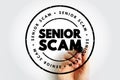 Senior Scam text inside a circular distressed stamp design with a hand writing behind it, representing fraud prevention, elder Royalty Free Stock Photo