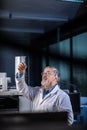 Senior scientist in a chemistry lab carrying out research - looking at gas chromatography samples Royalty Free Stock Photo