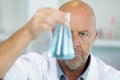 senior scientist holding flask in chemical lab Royalty Free Stock Photo