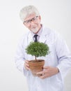 Senior scientist holding plant