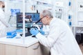 Senior scientist preparing and analyzing microscope slides Royalty Free Stock Photo