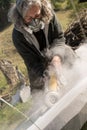 Senior sculptor polishing stone with grinder